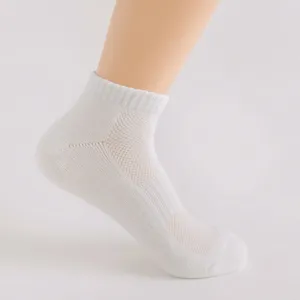 Comfortable breathable women's solid color sports mesh short socks with towel bottom detail.