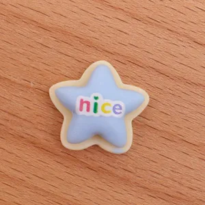 Detailed close-up of a cute blue star resin cabochon DIY charm for crafts and phone case deco.
