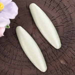 Close-up of handmade cream green fabric hair clips featuring soft satin texture and elegant style.