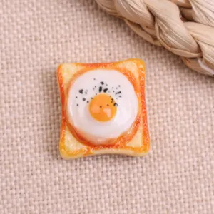 Detailed view of cute resin fried egg toast cabochon, perfect for DIY hair clips and phone cases.