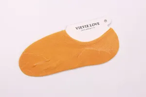 Detailed view of women's low-cut invisible solid color thin cotton boat socks in bright yellow.
