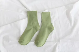 Green ribbed crew socks detail shot, simple and comfortable everyday cotton sock texture.