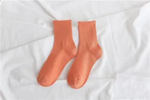 Comfortable solid orange mid-calf cotton socks for women and girls, ideal for daily wear.