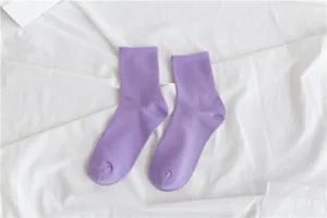 Close-up detail of purple cotton crew socks, soft fabric texture and solid color design.
