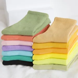 Women colorful cotton crew socks stacked neatly, casual daily wear or sports skateboard socks.