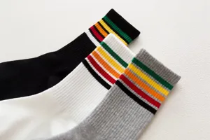 Women athletic striped tube socks detail close-up shot, showing colorful ribbed cuffs.