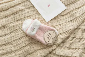 Fluffy pink winter fuzzy floor socks detail view, cozy warm coral fleece sleep sock soft.