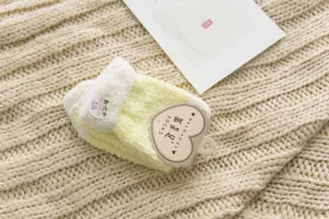 Cozy coral fleece home socks detail, soft yellow and white plush winter floor socks.