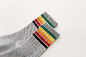 Detailed view of women's mid-tube cotton socks with colorful striped cuffs in grey.
