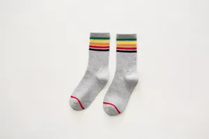 Detailed shot of retro striped women crew socks, featuring colorful top bands and soft cotton.