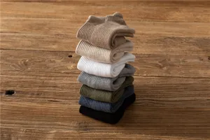 Detailed view of stacked men's thick towel bottom short socks in multi colors for cozy daily wear.