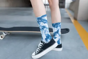 Close-up of blue and white tie-dye mid-calf cotton socks with vintage ink print design.