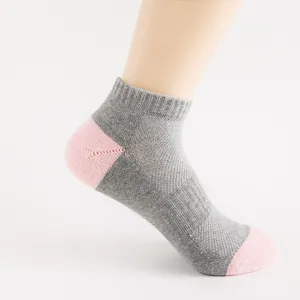 Grey and pink ankle sock detail, breathable mesh design, comfortable athletic sock view.