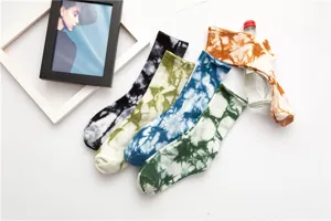 Detailed view of women's colorful tie dye crew socks, vintage ink print cotton socks, street style.