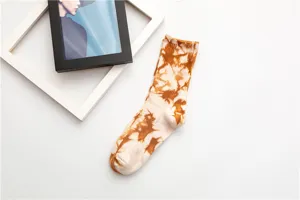 Detail shot of retro tie-dye mid-calf cotton socks in brown and white, soft streetwear style.
