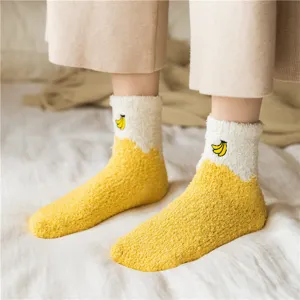 Primo piano dettagliato di calzini in pile corallo con ricamo di banane, caldi.