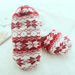 Close-up detail of winter fuzzy fleece floor socks with red Nordic snowflake pattern grips.