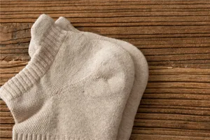 Close-up detail of thickened loop men boat socks in light khaki, soft fabric texture.