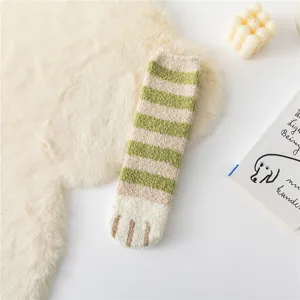 Cozy green striped fuzzy socks featuring cute cat paw design, soft winter home wear detail.