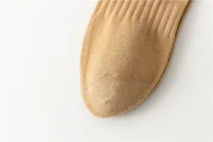 Closeup detail of men's casual ribbed cotton socks in camel color showing fine knit texture.