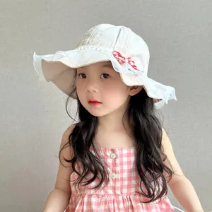 Cute kids sun hat with lace ruffles and bow, lightweight cotton summer toddler bucket hat.