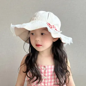Close-up detail of cute infant sun hat with lace ruffle and bow for little girls daily wear.