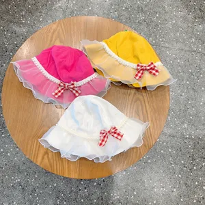 Cute kids bucket hat detail view showing delicate organza lace ruffles, pearl trim, and sweet bows.