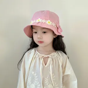 Cute pink bucket hat with white daisy lace trim and matching embroidered blouse for toddler girls.