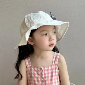 Toddler sun hat detail, white cotton fisherman hat with cute houndstooth bow, sweet style.