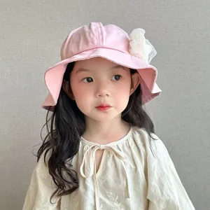 Close-up detail of the cute pink children bucket hat featuring delicate white lace flower.
