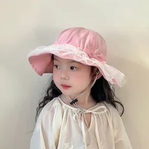 Close-up detail of cute pink toddler sun hat featuring delicate lace trim and sweet bow.
