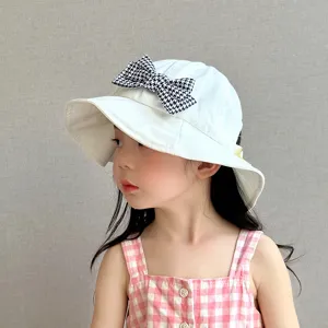Detailed view of cute baby girl bucket hat with houndstooth bow, white cotton sun hat.