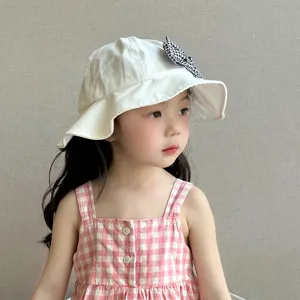 Kids sun protection bucket hat detail, cute bow decoration, soft cotton fabric for infants.