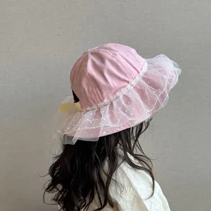 Cute pink baby bucket hat with white dot mesh ruffles and adjustable strap for toddler girls.