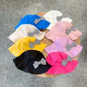 Detailed view of colorful children bucket hats with cute houndstooth bow knots for daily wear