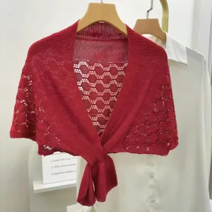 Detailed view of red hollow knit shawl, summer lightweight shrug cardigan with tie knot.