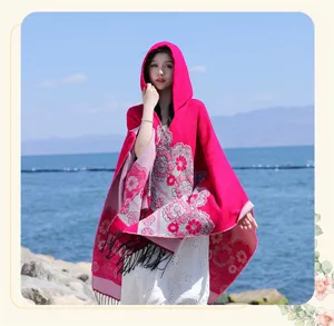 Ethnic floral tassel hooded knitted cloak cape for women, thick warm vacation outdoor wear.