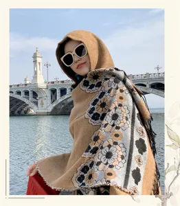 Detail view of ethnic floral tassel hooded cape, showcasing warm thick fabric in outdoor travel.