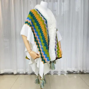 Colorful knit poncho with faux fur collar and fringe hem, cozy winter cape for women.