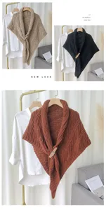 Detailed view of the stylish knitted shawl cape featuring a unique leather buckle design.