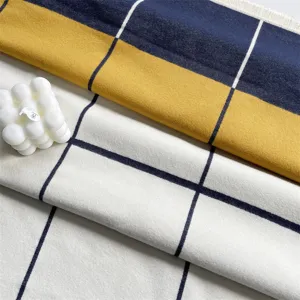 Detailed shot of color block imitation cashmere square scarf with fringe, warm and soft.
