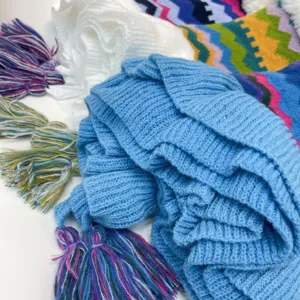 Cozy knit winter scarf with colorful stripes and fringe detail, warm and stylish accessory.