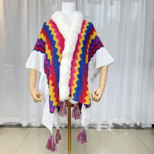 Colorful striped knitted poncho with faux fur collar and tassels for autumn winter wear.