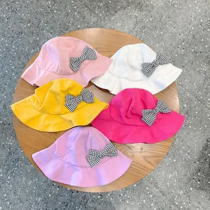 Cute kids bucket hat with houndstooth bow detail, colorful variant collection display.