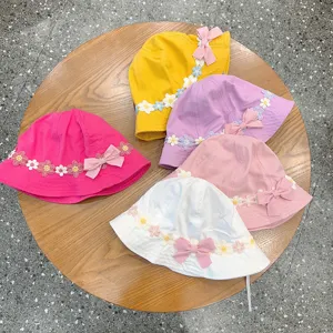Cute kids bucket hat with lace floral trim and bow, perfect baby sun hat for spring and summer.