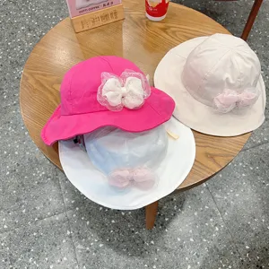 Detailed view of children bucket hats with cute mesh bow, soft cotton baby sun protection hats.
