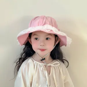 Cute pink baby bucket hat with white lace trim and adjustable strap for little girls, spring