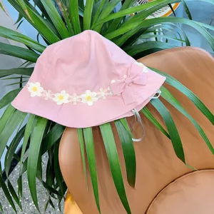 Close-up detail of the cute pink baby bucket hat with delicate floral embroidery trim.