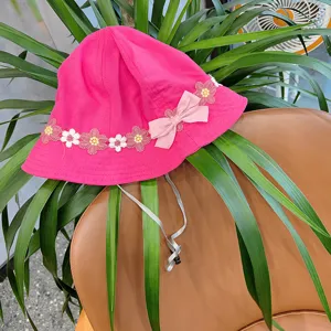 Cute pink baby bucket hat for little girls, featuring lovely floral embroidery and sweet bow tie.