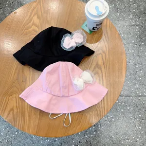 Detail view of cute baby bucket hats with mesh bows, soft fabric and adjustable chin strap.